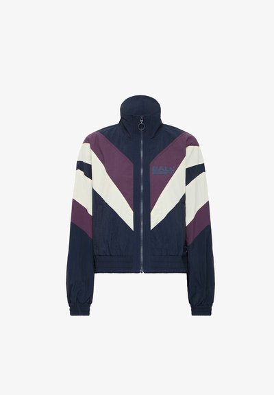 Navy, purple, and cream zip-up jacket with high collar, chevron design, elastic cuffs, and waistband. Features logo on the left side.