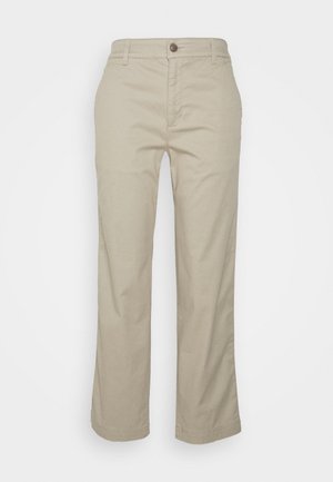Pantalons en coton beige à coupe droite, avec fermeture à bouton et poches avant. Texture lisse et détails de couture minimalistes.