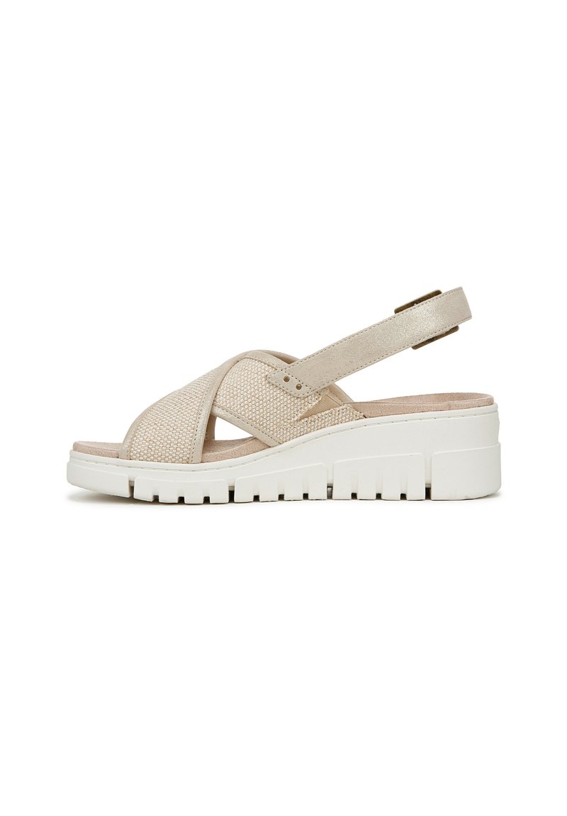 Beige wedge sandal with a fabric crossover design, adjustable ankle strap, and textured sole for grip. Lightweight and open-toe style.