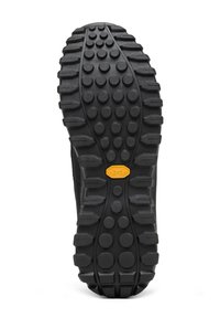 Semelle extérieure en Vibram noir avec des crampons ronds et hexagonaux proéminents pour une meilleure traction ; surface texturée avec un logo central en jaune.