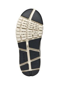 Suela de zapatilla de goma negra y crema con una superficie texturizada, patrones hexagonales y agujeros de ventilación para una mejor transpirabilidad.
