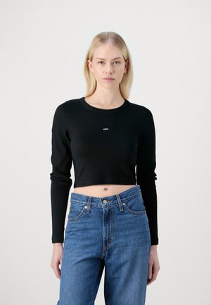Black cropped long-sleeve top with ribbed texture and a round neckline. Features the logo "J4XX" in white centered on the chest.
