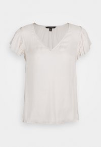 Ljusbeige blus med V-hals och korta volangärmar. Tillverkad av ett mjukt, lätt tyg med en avslappnad passform och rak nederkant.