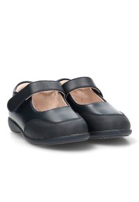 Zapatos Mary Jane negros con un upper de cuero liso y una suela de goma texturizada. Presentan una correa ancha en el arco del pie y una punta redondeada.