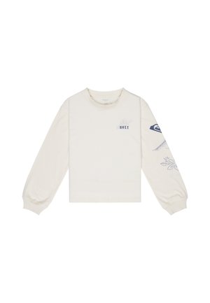 Crop top à manches longues de couleur crème, fabriqué en tissu doux, avec des motifs floraux bleus et un logo sur la poitrine et la manche.