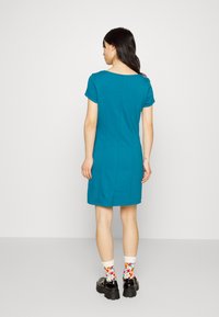 Vestido curto de mangas curtas na cor azul-água, com decote redondo, design ajustado e comprimento até ao joelho. Apresenta um detalhe de costura subtil e parece suave.