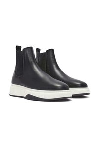 Black leather ankle boots with elastic side panels, white midsole, rounded toe, and textured finish. Loop tabs for easy wear.