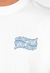 White cotton T-shirt featuring a wavy, blue graphic text "DROPSIZE" printed on the front, positioned slightly off-center.