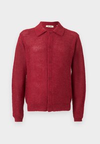 Red knitted cardigan with a button-down front, collar, and ribbed cuffs. Features an open weave pattern and a relaxed fit.