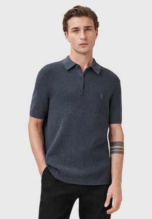 Korte mouw polo shirt in donker marineblauw, van een gestructureerd breisel, met een kraag en drie knopen aan de sluiting, subtiele logo-detail.