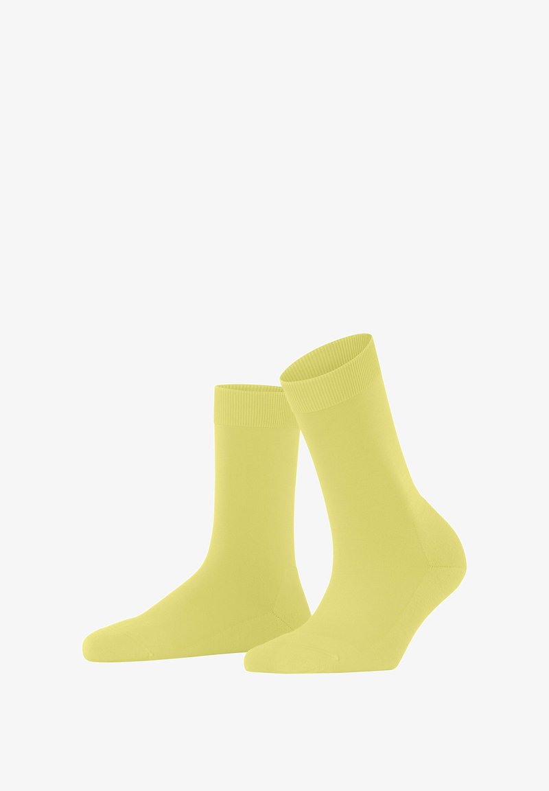 Żółte bawełniane skarpetki z żeberkowym ściągaczem, gładką fakturą, długości do połowy łydki oraz bezszwowym wykończeniem palców.