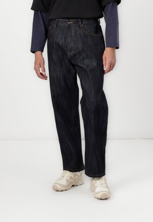 Dark denim trousers, straight leg cut, featuring a classic five-pocket design, orange stitching, and a button closure at the waist.