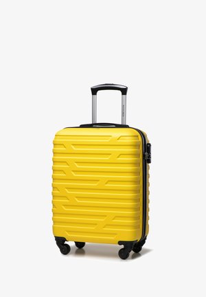 Gelbes Hartschalentrolley mit gerilltem Muster, schwarzem Reißverschluss und Griff, vier Rollen für Mobilität sowie einem teleskopierbaren Aluminiumgriff.