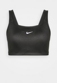 Soutien-gorge de sport noir avec une texture lisse, décolleté carré et larges bretelles. Présente le logo Nike blanc centré sur le devant.