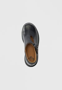 Μαύρο δερμάτινο παπούτσι με ανάγλυφο σχέδιο κροκοδείλου, λουράκι T-bar και κούμπωμα με πόρπη. Στρογγυλεμένη μύτη και μαλακή εσωτερική σόλα. Λείο, λαμπερό φινίρισμα.