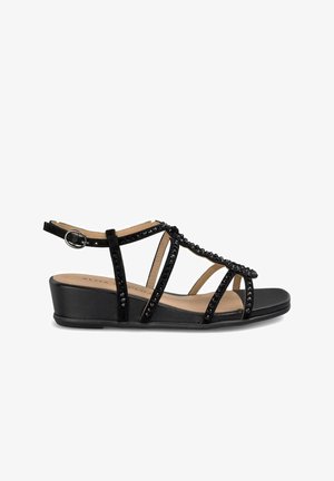 Sandale negre cu curele, decorate cu mărgele negre lucioase, cu toc wedge și curea pentru gleznă ajustabilă pentru un fit stabil și confortabil.