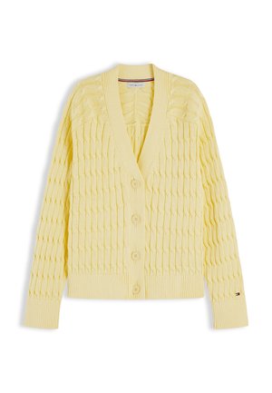 Keltainen neulottu neuletakki, jossa on letkuhiuskuvio, V-aukko, pitkät hihat, neljä edessä olevaa nappia sekä resorit hihansuissa ja helmassa.