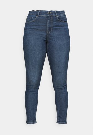 Jean skinny en denim bleu foncé, avec une taille mi-haute, quatre poches et une texture lisse avec un léger délavage sur les cuisses.