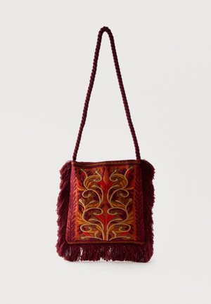 Square maroon shoulder bag with twisted strap, fringed edges, and intricate gold, red, and orange floral embroidery on front panel.
