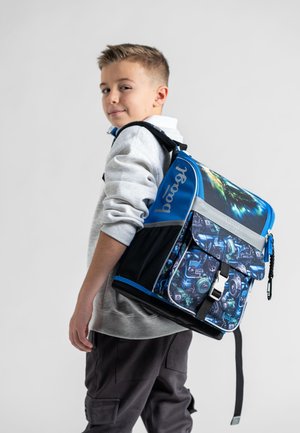 Blue and black backpack with a graphic pattern of machinery, features padded back, adjustable straps, and a clip closure. Durable fabric.
