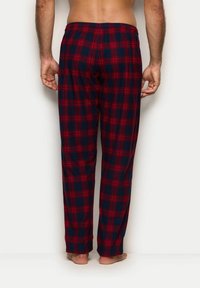 Czerwono-granatowe spodnie piżamowe w kratę o luźnym kroju, z elastycznym pasem i szerokimi nogawkami. Miękka tkanina o gładkiej fakturze.