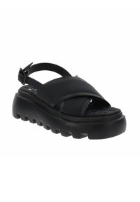 Zwarte sandaal met kruislings gespen, verstelbare enkelriem, een dikke zool met profiel en een gevulde voetbed voor extra comfort.