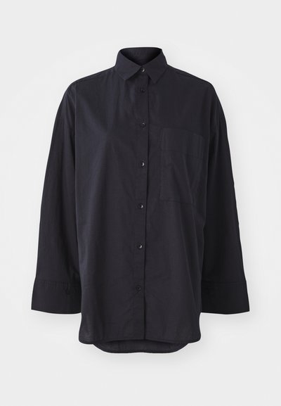 Black button-up shirt made of soft fabric, featuring a classic collar, long sleeves, a chest pocket, and a curved hem design.
