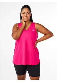 Bright pink sleeveless athletic top with a V-neck design, made of lightweight fabric. Paired with black bike shorts. Subtle logo detail.
