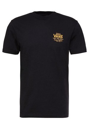 T-shirt noir à manches courtes avec petit logo jaune Vans « Off The Wall » et texte sur le côté gauche de la poitrine.