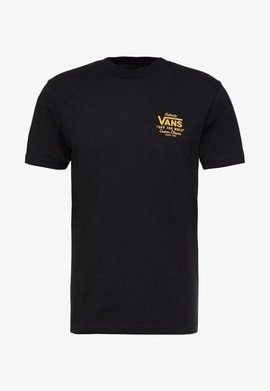 T-shirt noir à manches courtes avec petit logo jaune Vans « Off The Wall » et texte sur le côté gauche de la poitrine.