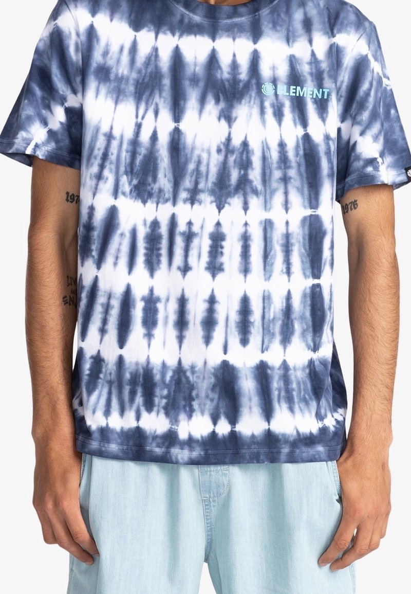 Marinblå och vit tie-dye t-shirt med korta ärmar, rund halsringning och en liten turkos logotyp på bröstet; mjukt bomullsmaterial, avslappnad passform.