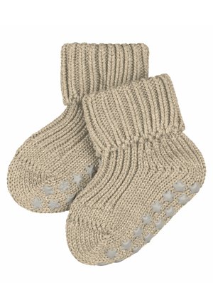 Beige gestrickte Babysocken mit einem gerippten Bündchen und rutschfesten Sohlen mit Sternmuster für Halt und Sicherheit. Weiche, strukturierte Wolle für Komfort.