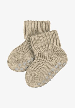 Beige gestrickte Babysocken mit einem gerippten Bündchen und rutschfesten Sohlen mit Sternmuster für Halt und Sicherheit. Weiche, strukturierte Wolle für Komfort.