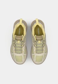Light yellow mesh sneakers with beige accents, featuring a braided lace system, padded collar, and rubber outsole for traction.