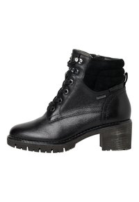 Bottines en cuir noir avec lacets à l'avant, col rembourré, talon épais et semelle robuste, idéales pour les activités en extérieur ou un style décontracté.