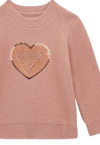 Maglione rosa con una consistenza morbida, caratterizzato da una patch di paillettes a forma di cuore con la parola "GUESS" al centro e collo e polsini a coste.