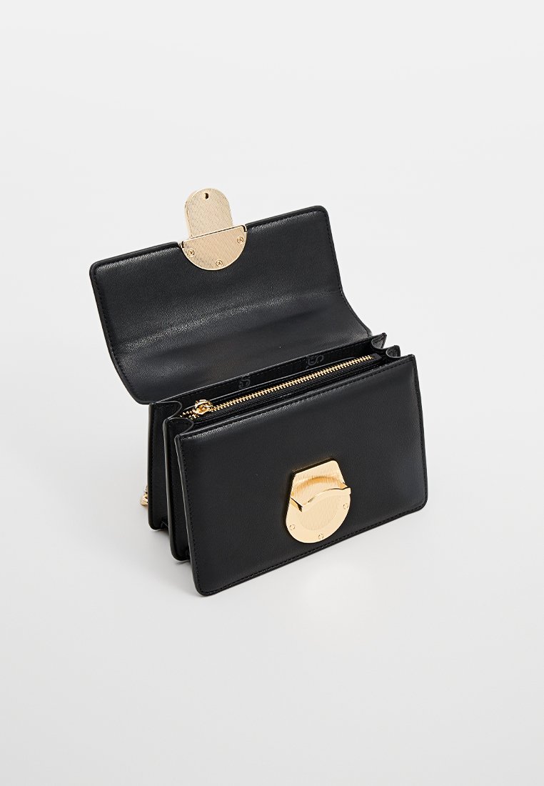Schwarze Lederportemonnaie mit goldenem Metallverschluss, offen, um mehrere Fächer und einen Reißverschlussbereich im Inneren zu zeigen.