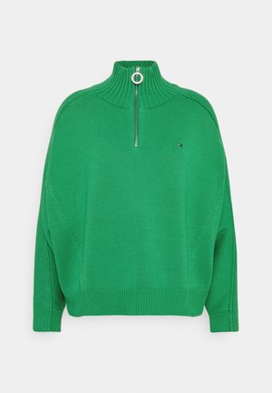 Pull vert en tricot avec col haut côtelé, demi-fermeture éclair avec tirette ronde, manches longues et petit logo sur le côté gauche de la poitrine.