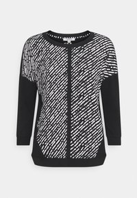 Schwarzer Pullover mit einem weißen abstrakten Muster. Lange Ärmel, runden Ausschnitt und einem strukturierten Stoff. Subtile Details an den Seitenpaneelen.