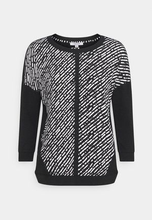 Zwarte pullover met een wit abstract patroon. Lange mouwen, ronde halslijn en een gestructureerde stof. Subtiele details op de zijpanelen.