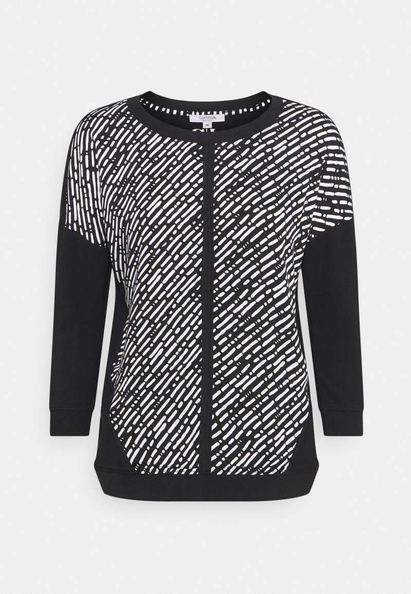 Schwarzer Pullover mit einem weißen abstrakten Muster. Lange Ärmel, runden Ausschnitt und einem strukturierten Stoff. Subtile Details an den Seitenpaneelen.