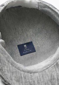 Gray bow tie with a smooth fabric texture. Interior features a blue label with a graphic and text: "Prince Bow Tie."