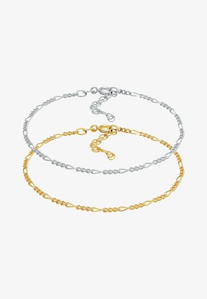 Sidabriniai ir auksiniai sluoksniuoti apyrankės su tarpusavyje susijusiomis grandinėmis. Kiekviena apyrankė turi arklio uodegos segtuką ir reguliuojamą ilgį.