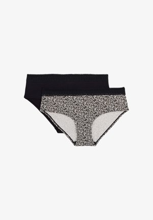 Deux culottes hipster pour femmes, une noire et une avec imprimé léopard, toutes deux avec une ceinture en dentelle, posées à plat sur fond blanc.