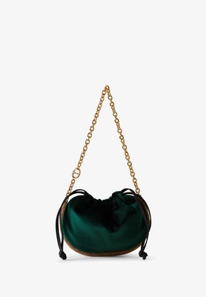 Green velvet pouch-style handbag with black drawstring sides, textured tan base, and a gold chain shoulder strap.