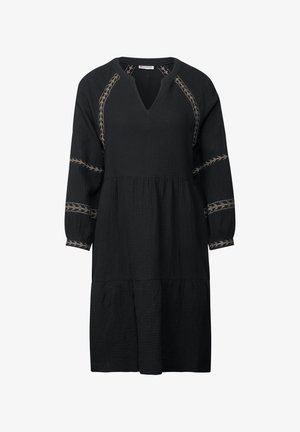 Zwart jurk met een V-hals en driekwart mouwen. Heeft een gestructureerde stof en decoratieve tan borduursels langs de schouders en de mouwen.