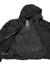 Black puffer jacket with a hood, front zip, and interior logo tags. The inner lining is smooth with a subtle logo pattern.