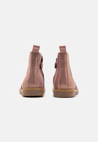 Różowe zamszowe botki za kostkę z elastycznymi panelami bocznymi i tylnymi uchwytami, z teksturowaną gumową podeszwą i wytłoczonym logo na pięcie.