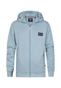 Ljusblå zip-up huvtröja gjord av mjukt material, med dragsko, framfickor och en liten logotyp på vänster bröst.