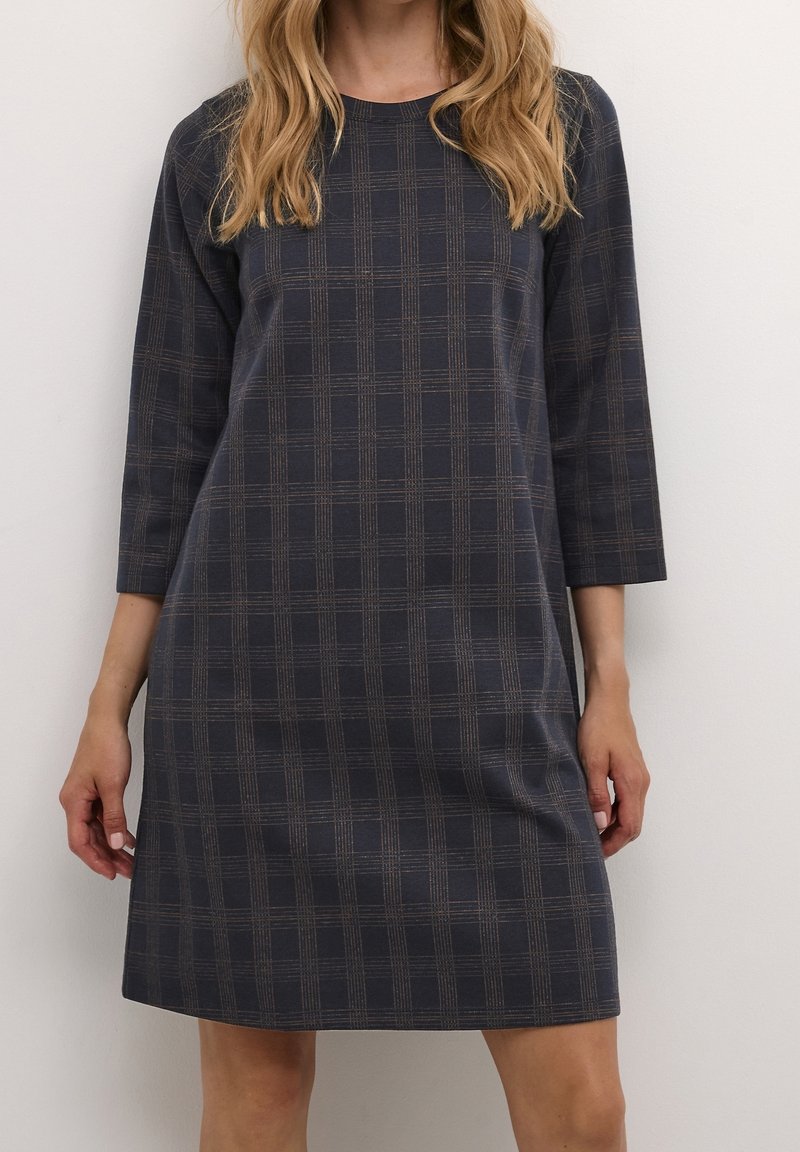 Abito a quadri blu navy con maniche a tre quarti, caratterizzato da linee marroni e grigie. Realizzato in un tessuto morbido con una vestibilità comoda.